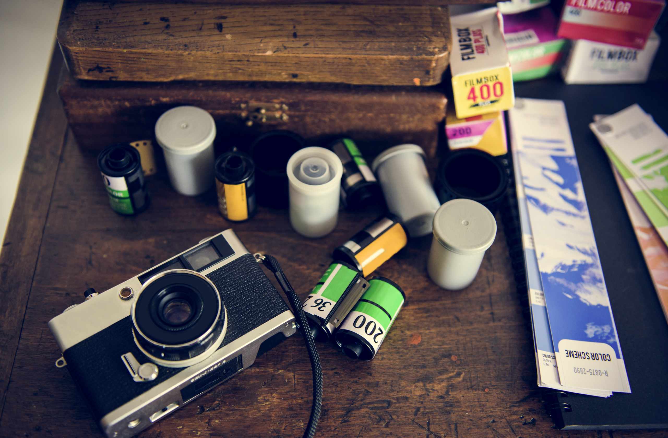 Vintage camera and film rolls on a wooden table
